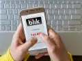 Ręce trzymają telefon z aplikacją Blik, na ekranie widoczny kod. Zastanawiasz się, jak cofnąć Blik? Ten obraz pokazuje, jak szybko uzyskać kod.