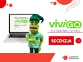 Zielona postać z pluszowym wizerunkiem zachęca do skorzystania z pożyczki vivigo. Na ekranie laptopa informacja o pierwszej pożyczce do 4000 zł RRSO 0%.