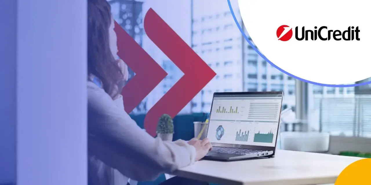 Kobieta analizuje dane na laptopie, obok logo UniCredit. Rozważasz UniCredit konto oszczędnościowe?