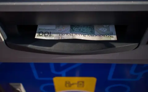 Banknot 100 zł włożony do wpłatomatu. Tak działa wpłatomat: wkładasz pieniądze, a urządzenie je przyjmuje.